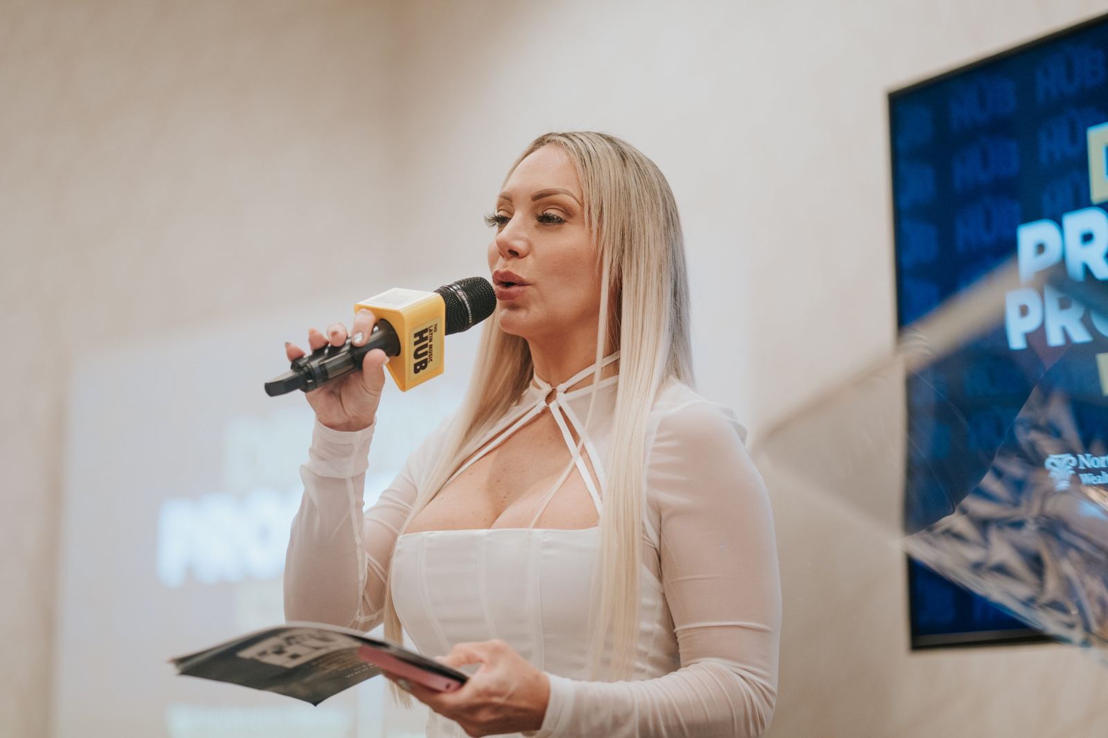 The host speaking into a Latin Music Hub microphone
